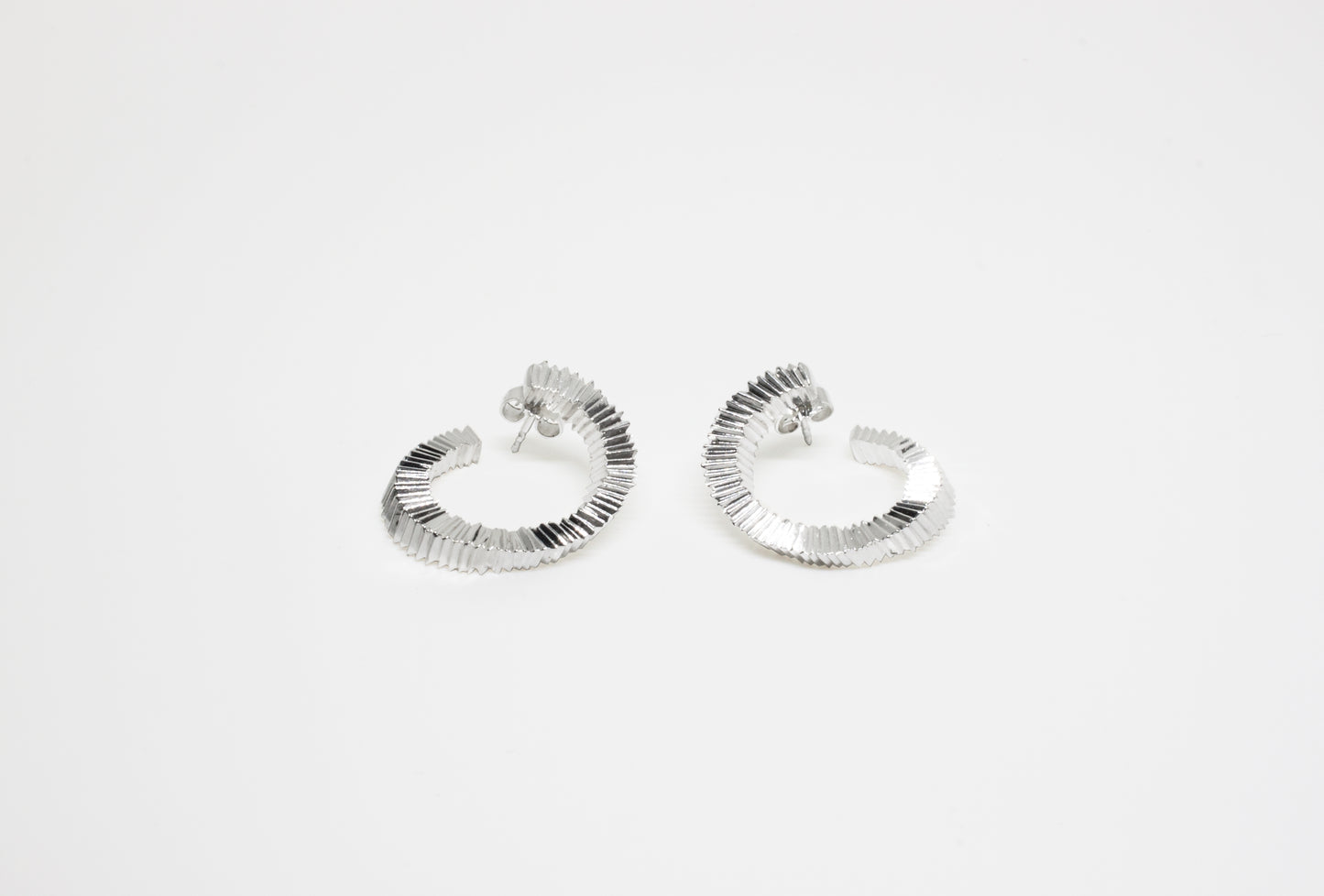 Hand-carved silver twisted earrings by Minou Lejeune, unique piece, sculptural design