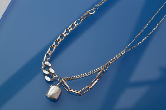 With Medaillon Necklace in silver and gold, collage-like recycled jewellery, one-of-a-kind by Minou Lejeune